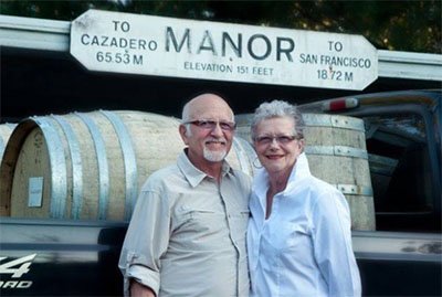 Frank and Ronita Egger standing before the historic Manor station sign